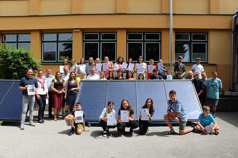 Gruppenbild Solarcamp Bad Mitterndorf: Schüler:innen, Projektleiter und Schuldirektion stehen vor gefertigter Solaranlage